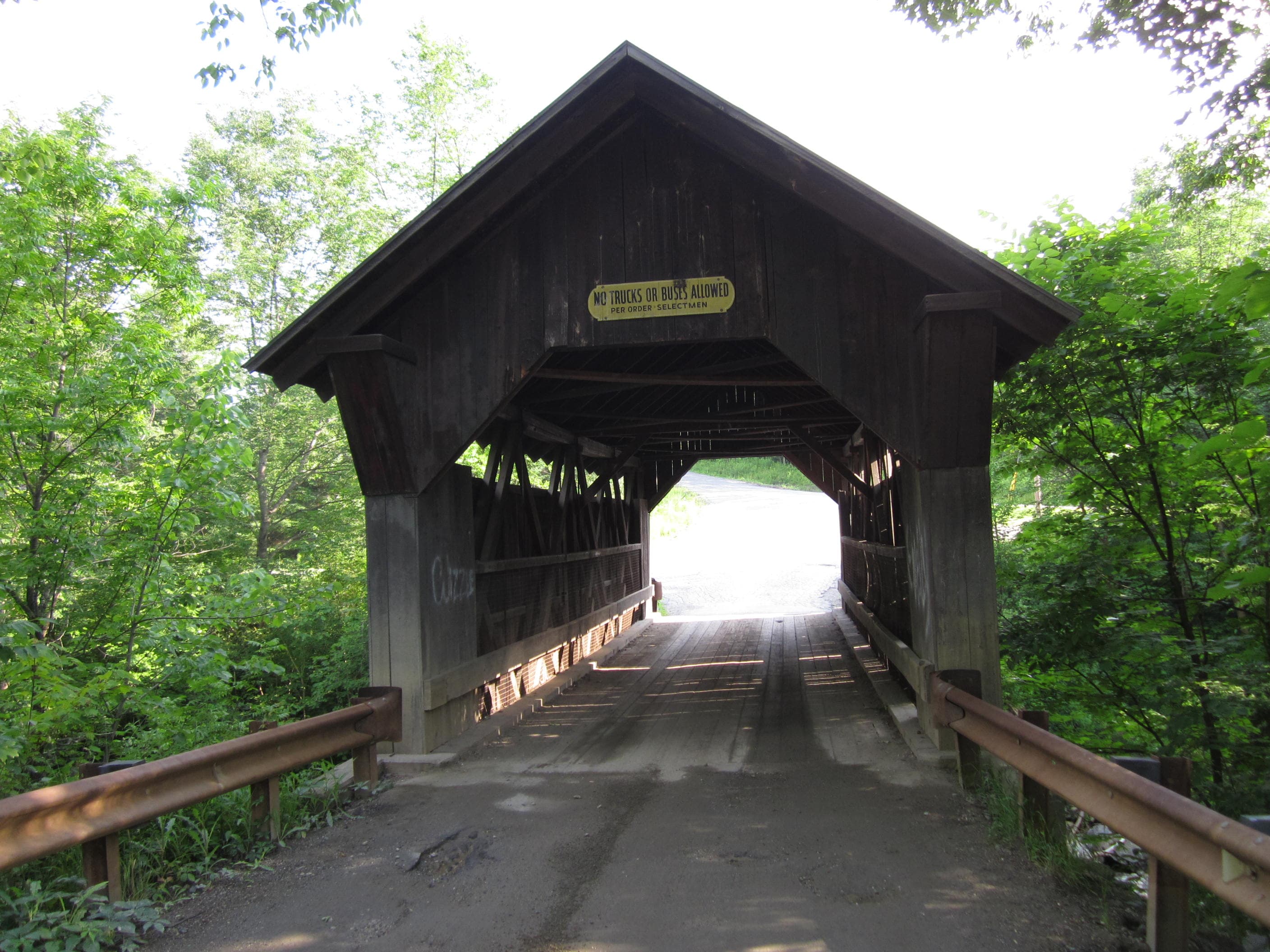 Gold Brook wading scene with rocks and trees along the brook near Stowe, Vermont.