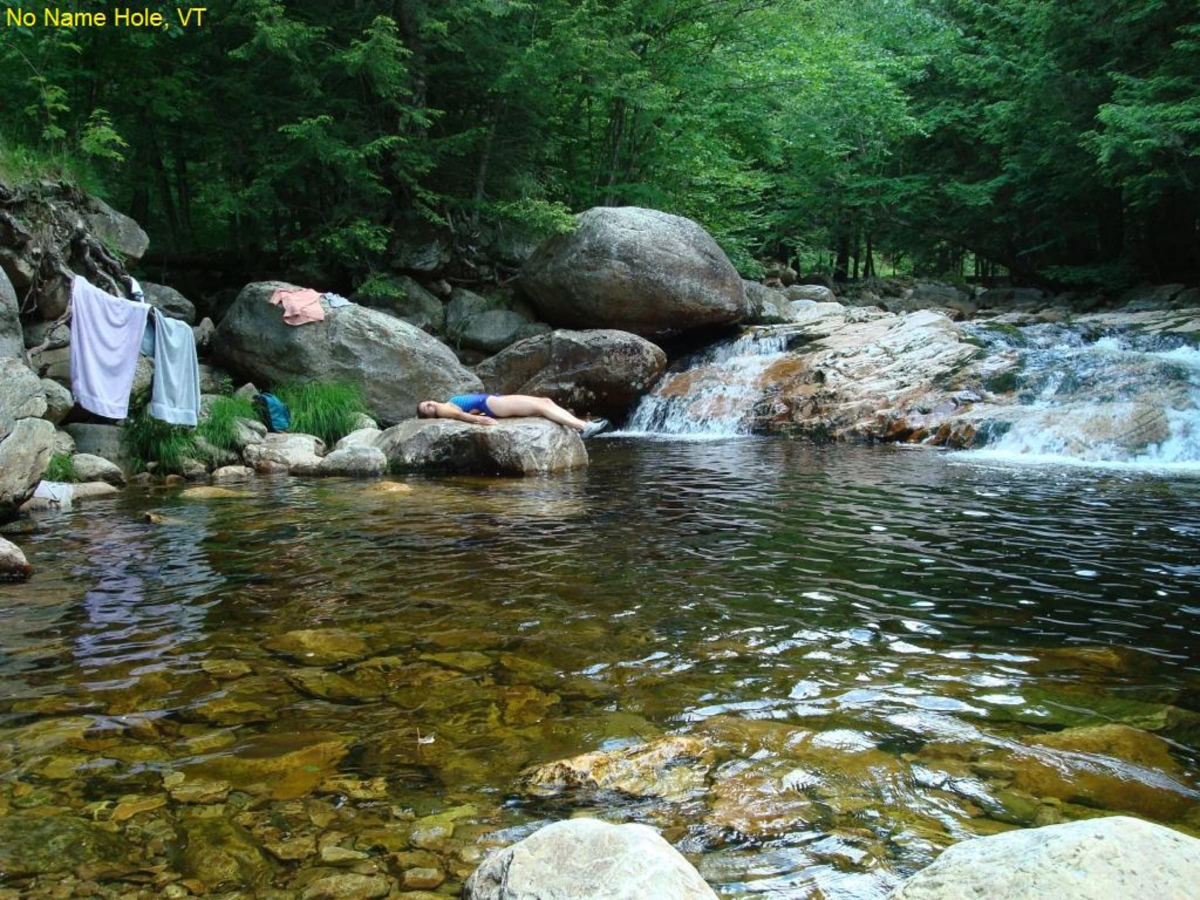 Pool and small cascades at Trout River Falls in a forested rocky corridor near Montgomery.