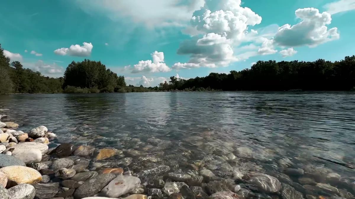 Clear New England river water and rocky shoreline in late-summer light.