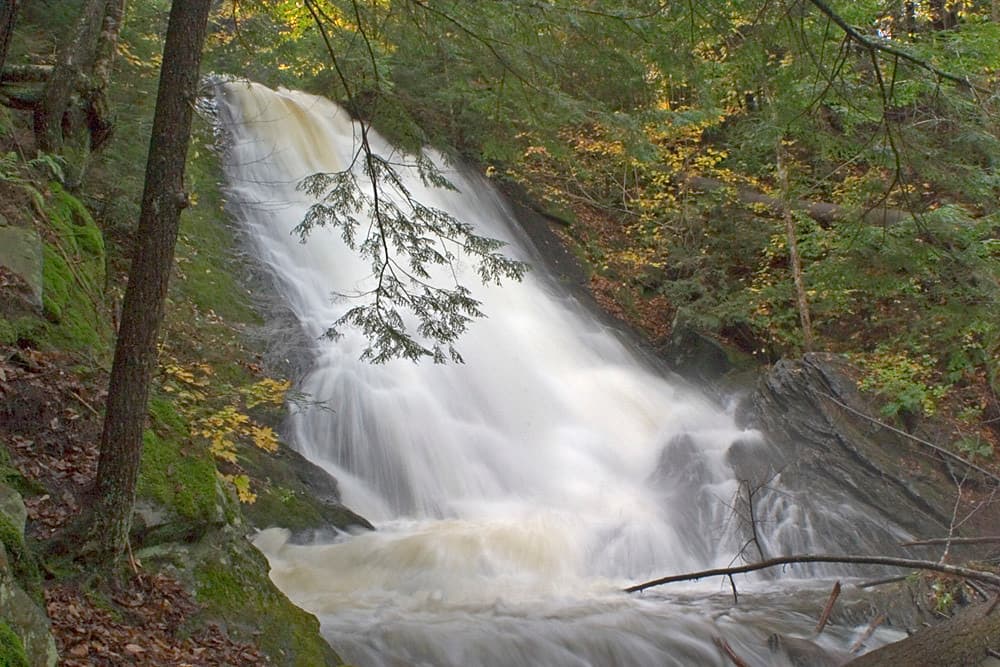 Thundering Brook Falls tiered cascade over dark rocks in Vermont