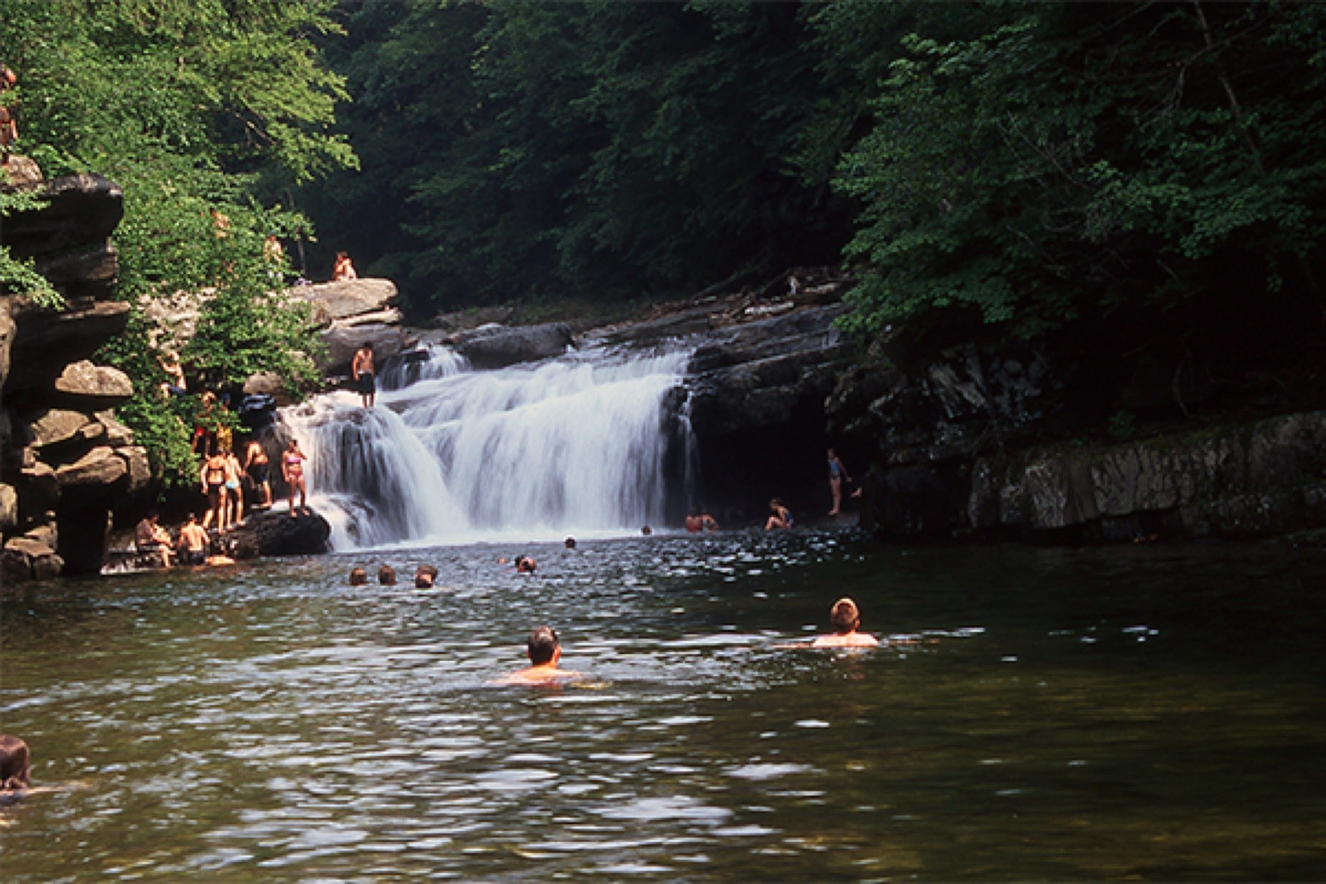 Waterfall pool in summer forest—used for Woodstock and Quechee planning.