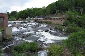 Black River rapids at Cavendish Gorge with old mill buildings along the riverbank in Cavendish, Vermont.