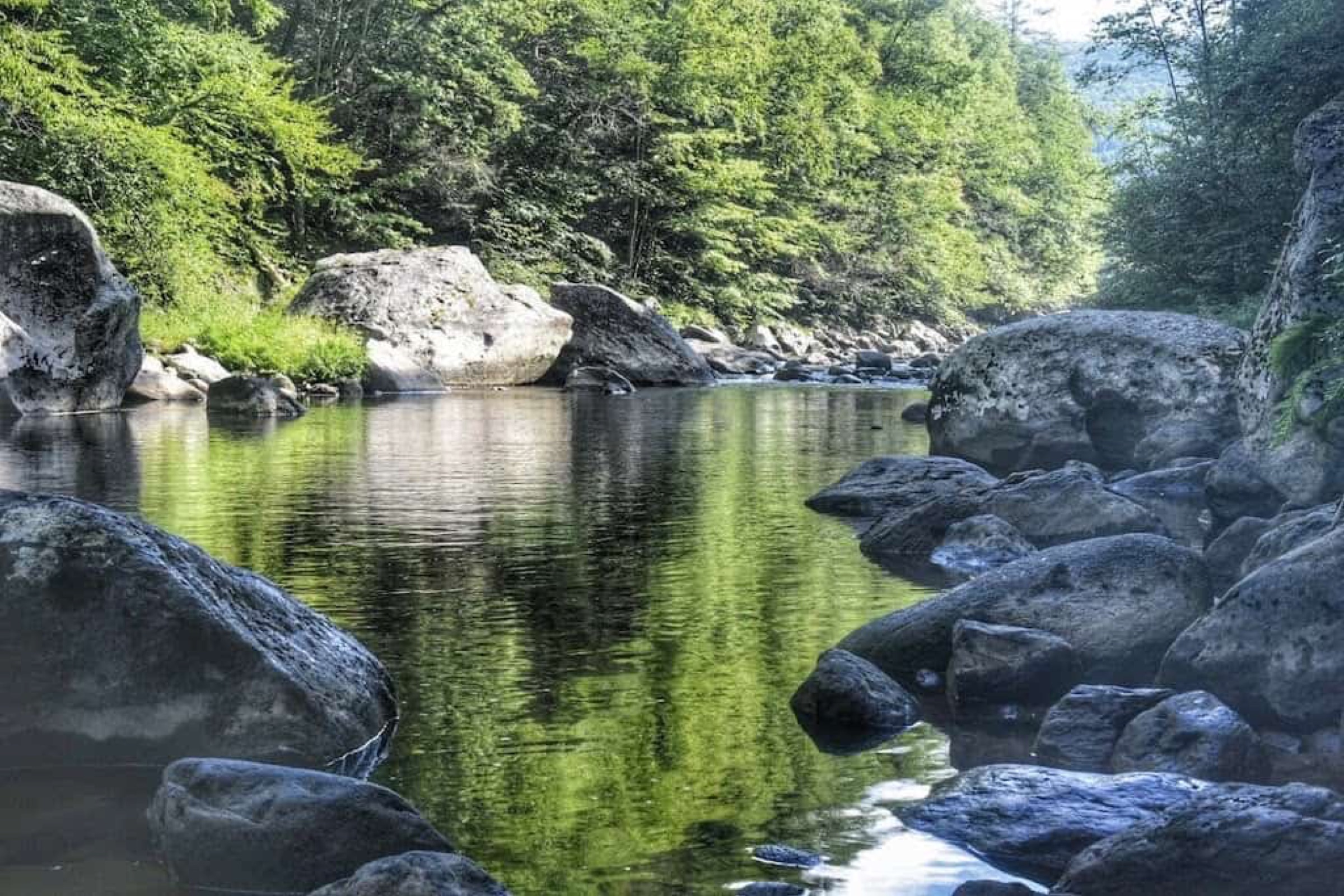 Shaded waterfall in New England on a hot summer day.