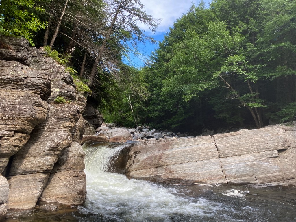 Bartlett Falls on the New Haven River at Lincoln Road near Bristol, Vermont—roadside cascade over dark rock with green forest