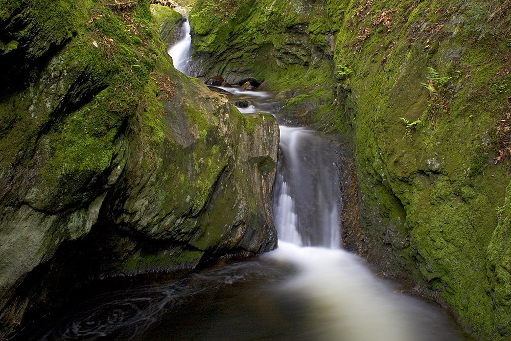 Sterling Gorge Falls cascade in the rocky gorge near Stowe, Vermont—mossy stone and forest-framed whitewater
