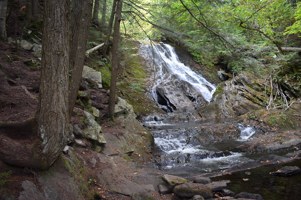 Tiered cascade on Thundering Brook over mossy rocks and forest pool, Thundering Brook Falls boardwalk area near Killington, Vermont
